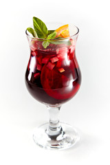 Red cocktail with fruits in a glass isolated on a white background