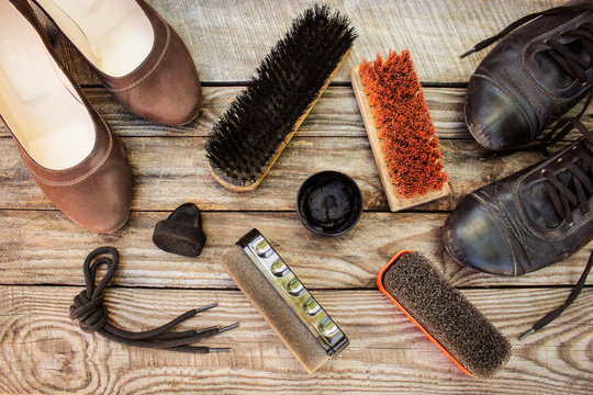 Women's shoes and care products for footwear on wooden background.