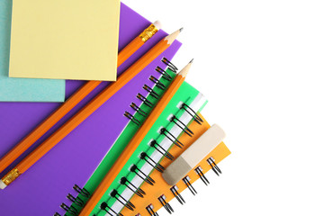 Fototapeta premium colorful notebooks with stickers and pencils with an eraser on white isolated background