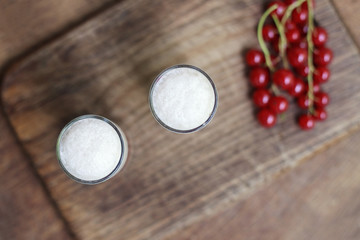 milkshake in a glass with a currant and raspberry on the backgro