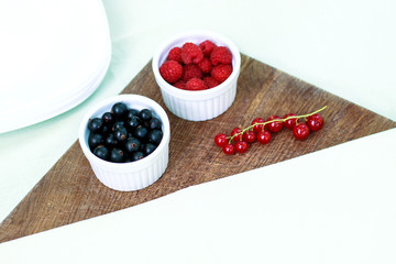 Assortment of berries - raspberries, gooseberries, red currants,