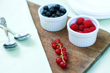 cottage cheese with berries and berry puree in a white bowl on a