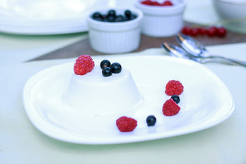 Sweet dessert with ice cream, blackcurrant and raspberries