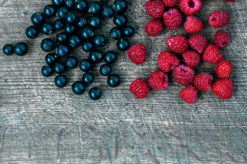 Mixed berries background with ripe delicious raspberries and bla