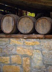 Old wine barrels on stone wall