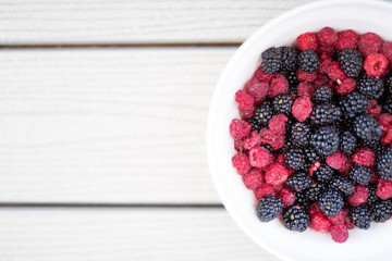 Organic Handpicked home orchard Raspberries,blackberries from bushes at the backyards in the natural growth,planted from northwest America with toned color and selective focus
