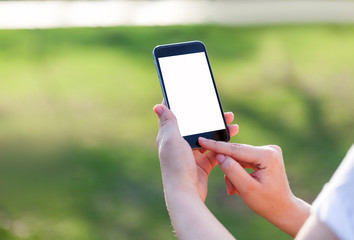 Woman using mobile smart phone in the park.