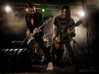 Rock band performs on stage.
