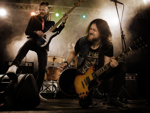 Rock band performs on stage.