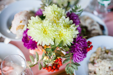 flowers in the vase on the banquet table