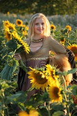 The beautiful blonde in a sunflower field