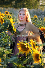 The beautiful blonde in a sunflower field