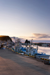 pier with crowded ships in japan hokkaido at sunrise