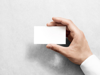 Hand holding blank plain white business card design mockup. Clear call id card mock up template...