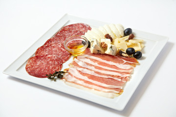 Assorted deli meats and cheese isolated on white