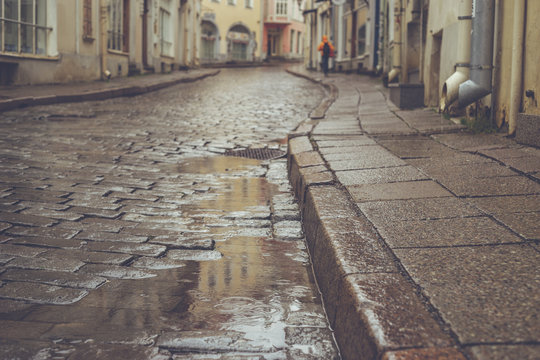 Old town pavement street on rainy day