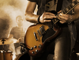 Rock band performs on stage. Guitarist. - obrazy, fototapety, plakaty