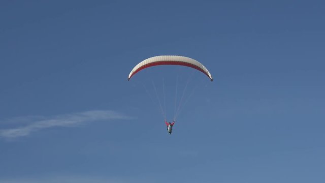 Paraglider folds his wing