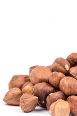 Pile of hazelnuts over white background