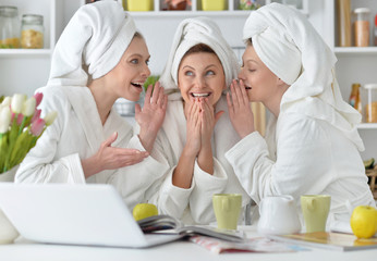 women wearing a white bathrobes with laptop