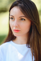 Fototapeta premium Woman smiling in a park and looking at side