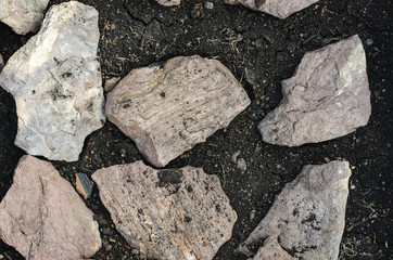 Natural Texture: Stones lie on a black soil