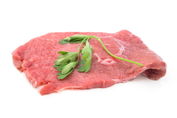 raw beef fillet with parsley on white