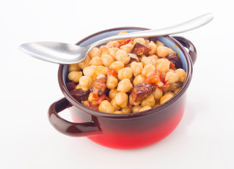 metal pot with chickpea stew with sausage