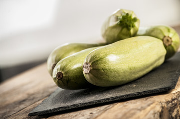 Fresh zucchini on wooden background