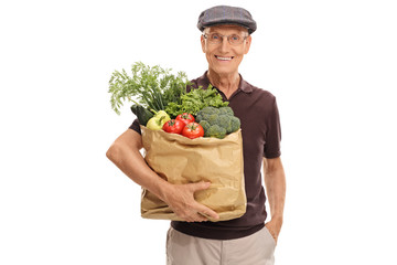 Elderly man holding a bag of groceries