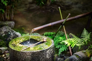 Foto op Plexiglas Traditional japanese bamboo fountain Ryoan-ji tsukubai at Ryoan-ji temple in Kyoto, Japan. The basin provided for ritual washing of the hands and mouth. © Nataliya Hora