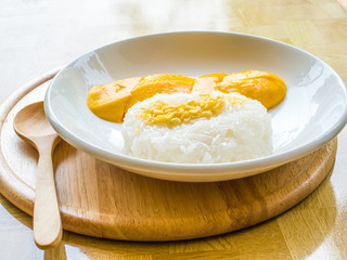 Mango with sticky rice on white plate