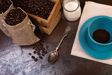 cup of coffee and jute bags, wooden container, cane sugar
