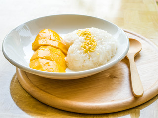 Mango with sticky rice on white plate