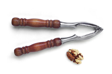Walnut kernel and nutcracker isolated on a white background. Top view