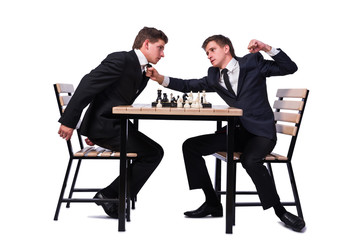 Fototapeta premium Twin brothers playing chess isolated on white