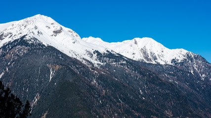 Snow capped summit under blue skies