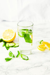 Lemonade with mint and ice in glass, morning, summer drink