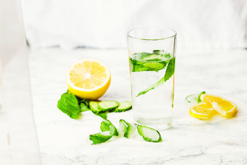 Lemonade with mint and ice in glass, morning, summer drink