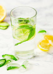 Lemonade with mint and ice in glass, morning, summer drink