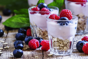 Sweet berry dessert with oatmeal, yogurt, blueberries and raspbe