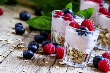 Sweet berry dessert with oatmeal, yogurt, blueberries and raspbe