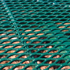 Close view of a green metal mesh table top