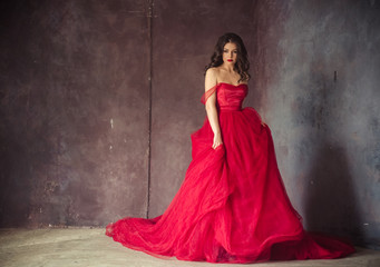 Fototapeta na wymiar portrait of sensual woman in a long gorgeous red dress