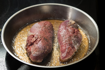 Duck fillet on grille pan. Poultry meat prepared on a grill. Fresh, delicious, spicy dish on a kitchen with copy space closeup and copy space.
