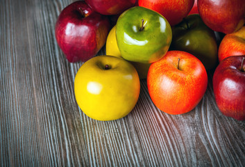 Red apples on wooden table close up top view