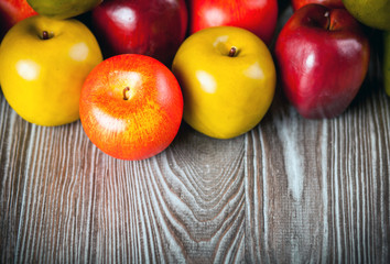 Red apples on wooden table close up copy space