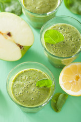 Fototapeta na wymiar healthy green spinach smoothie with apple lemon