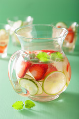refreshing summer drink with strawberry cucumber lime in jar and