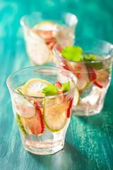 refreshing summer drink with strawberry cucumber lime in glasses